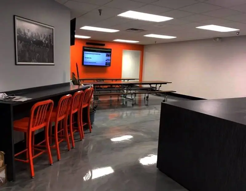 Commercial break room and bar area with a glossy coated floor