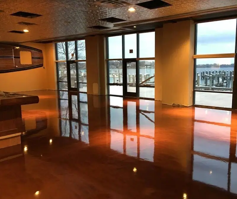 Glossy epoxy showroom floor reflecting large windows
