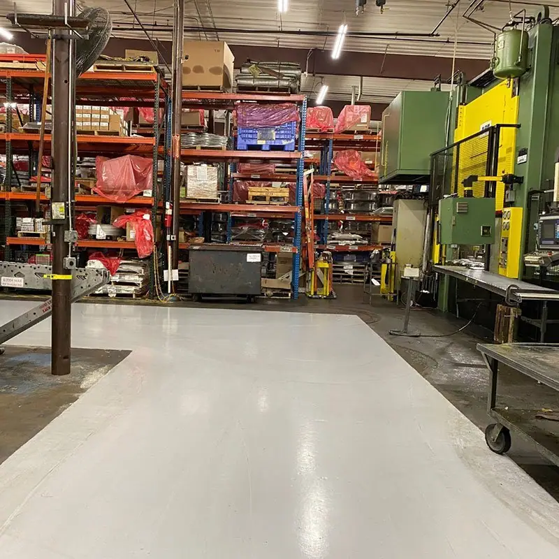 Manufacturing floor with machinery, racking and a coated epoxy floor
