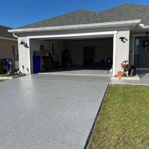 Coated flake driveway in front of a home's garage