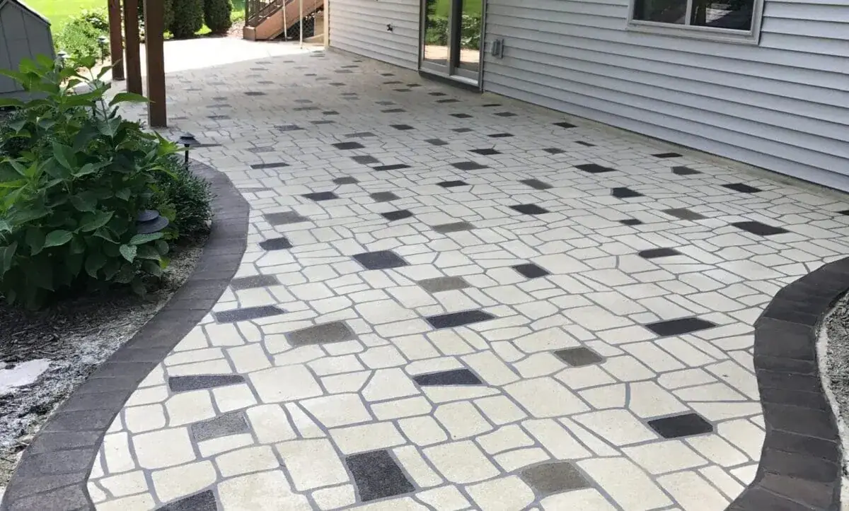 Decorative coated patio walkway beside a house