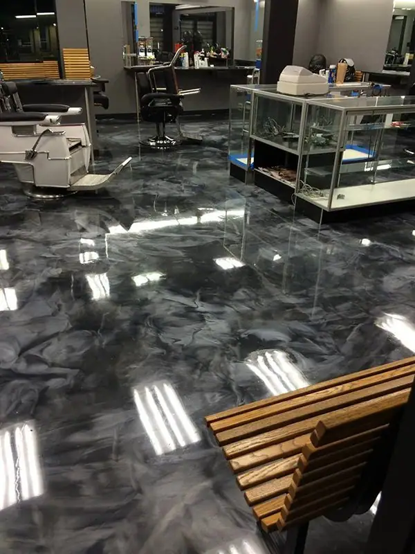 Dark metallic epoxy floor in a commercial display space