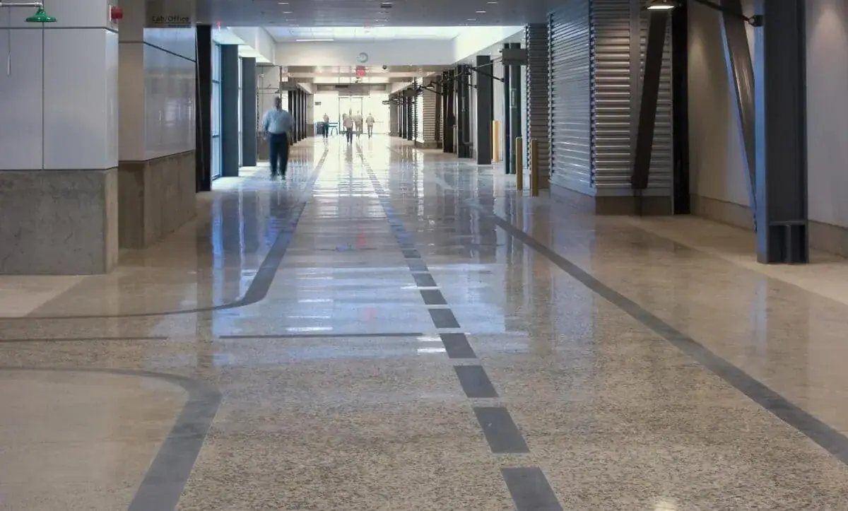 Long, bright hospital corridor with a seamless floor